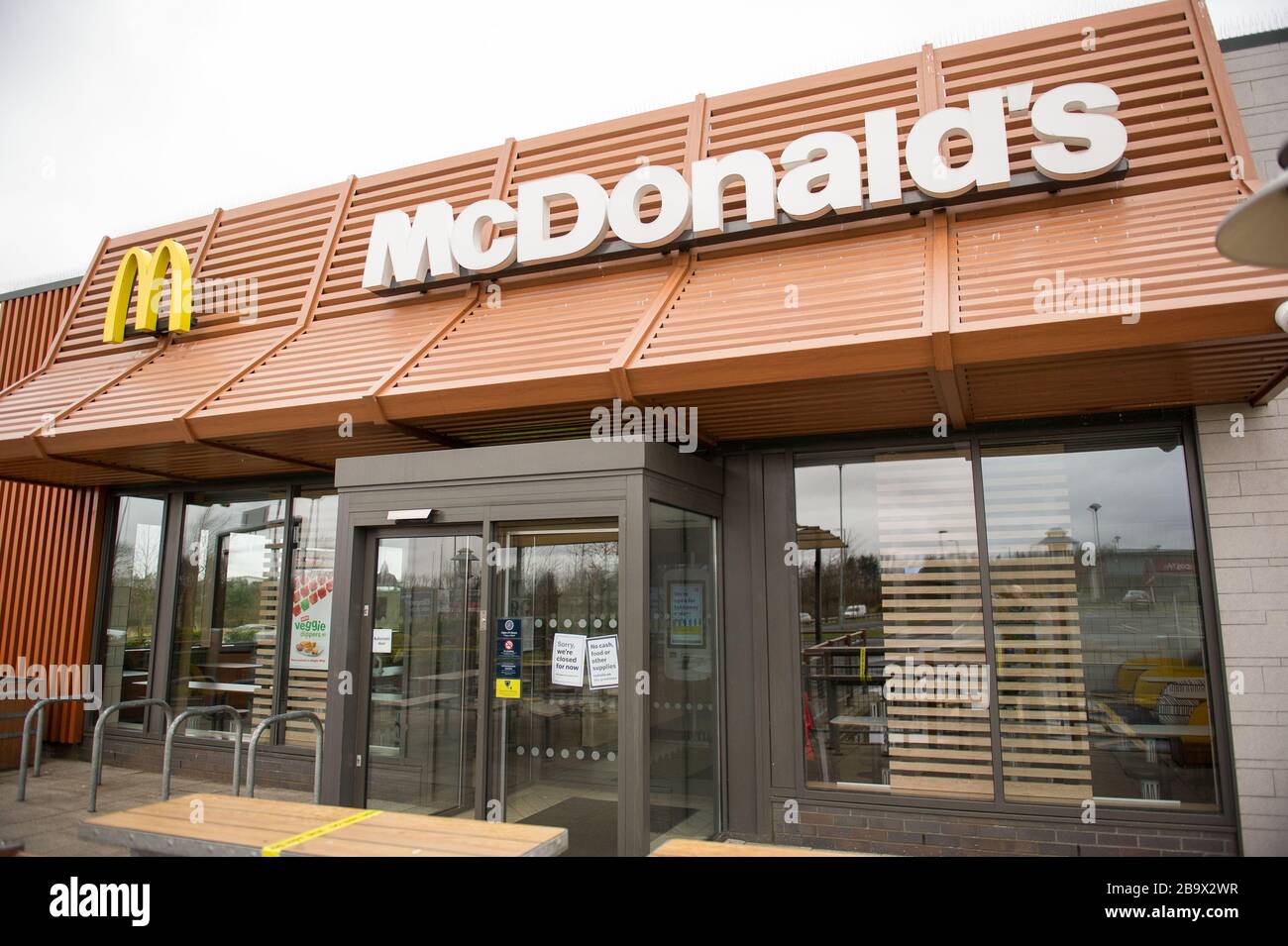 Glasgow, UK. 25th Mar, 2020. Pictured: McDonald's Restaurant in Bishopbriggs area of Glasgow is closed down due to the Coronavirus Pandemic. What would normally be a very busy drive thru and busy thoroughfare is more akin to a deserted building and surrounding carpark. Credit: Colin Fisher/Alamy Live News Stock Photo