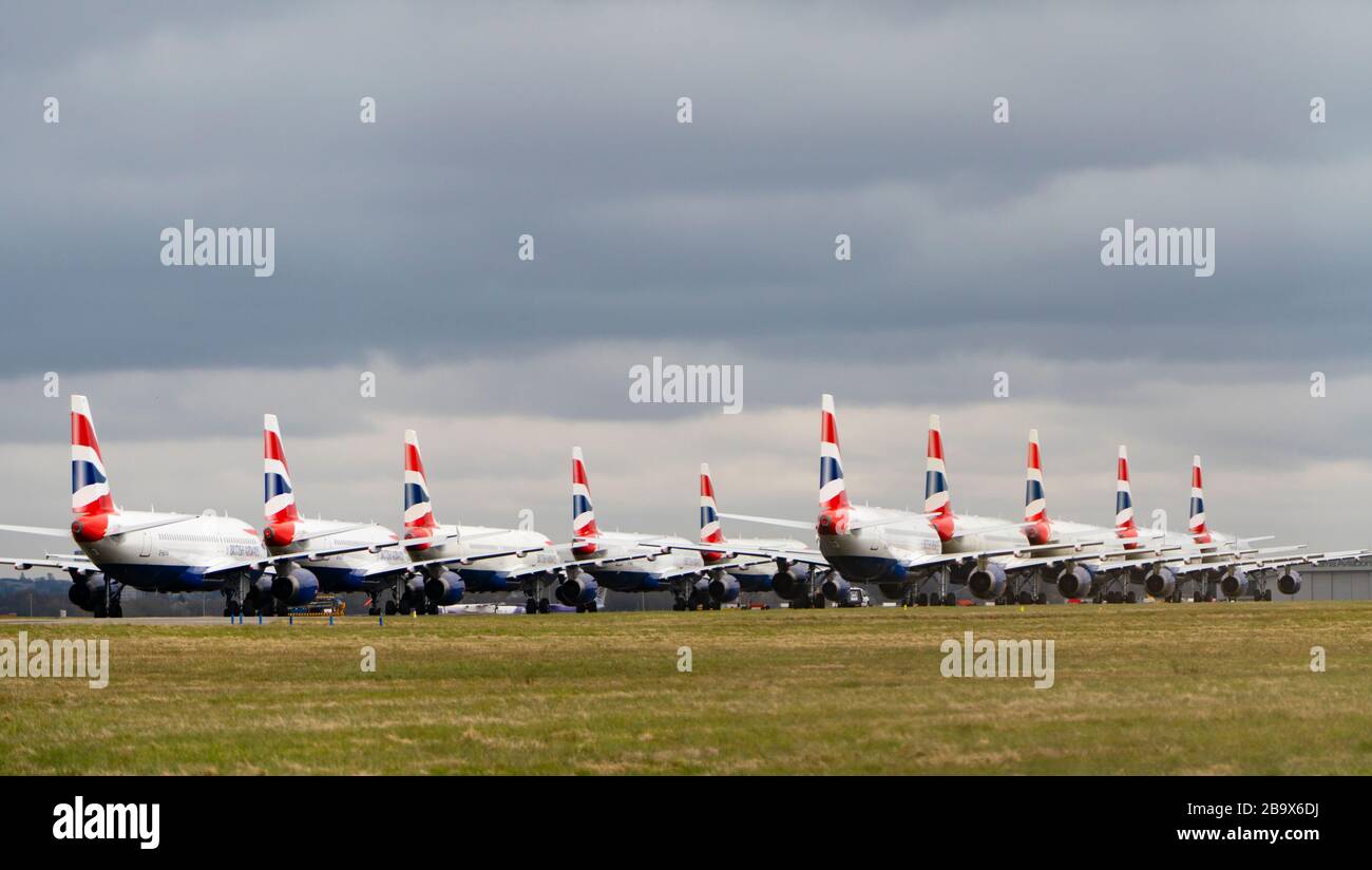 Glasgow, Scotland, UK. 25 March, 2020. Day two of the Government enforced lockdown in the UK. All shops and restaurants and most workplaces remain closed. Cities are very quiet with vast majority of population staying indoors. Pictured; British Airways passenger aircraft remain grounded and parked at Glasgow Airport. Iain Masterton/Alamy Live News Stock Photo