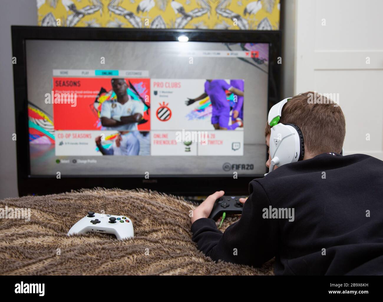Boy Plays FIFA 20 on Xbox Stock Photo