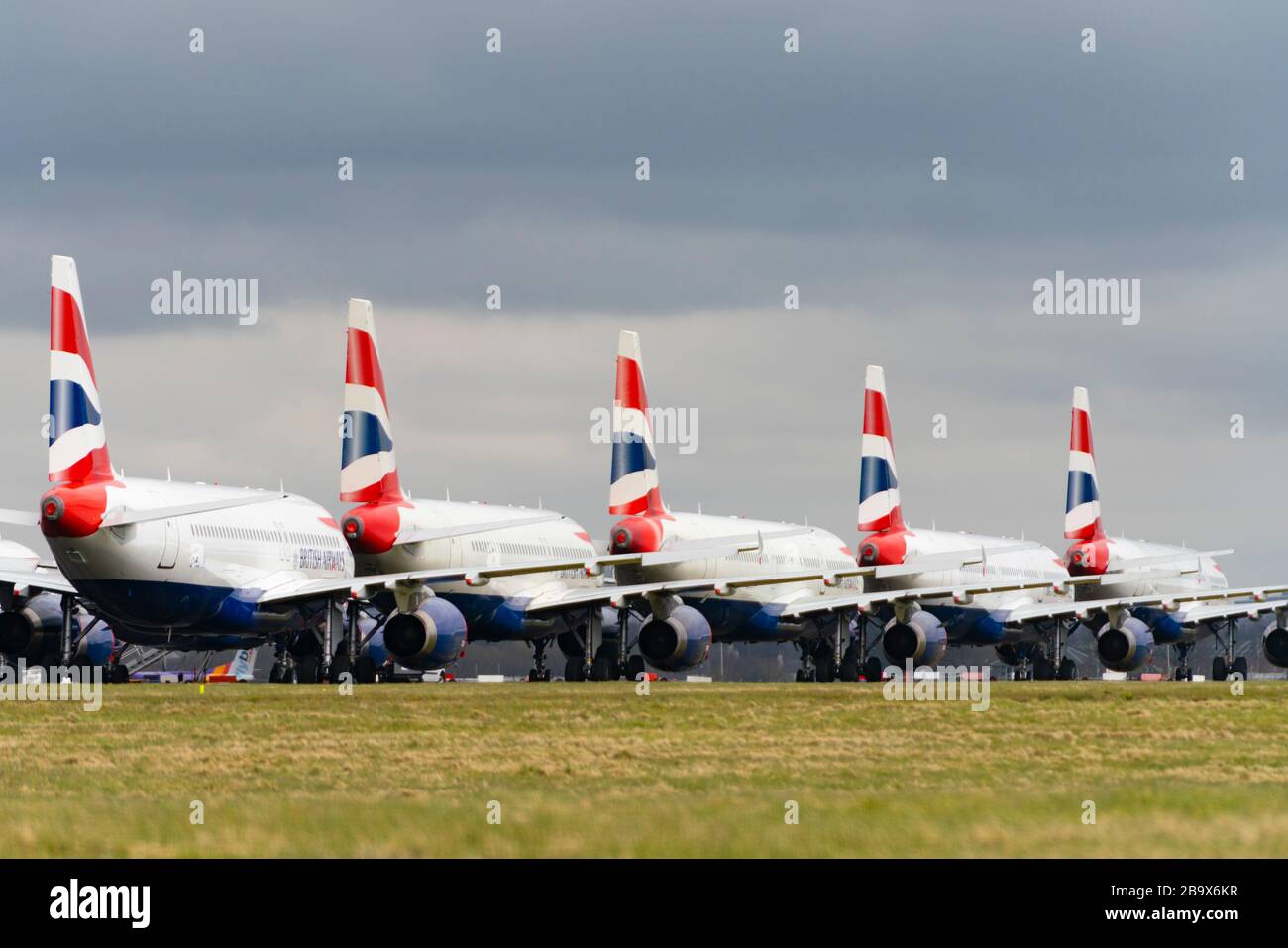 Glasgow, Scotland, UK. 25 March, 2020. Day two of the Government enforced lockdown in the UK. All shops and restaurants and most workplaces remain closed. Cities are very quiet with vast majority of population staying indoors. Pictured; British Airways passenger aircraft remain grounded and parked at Glasgow Airport. Iain Masterton/Alamy Live News Stock Photo