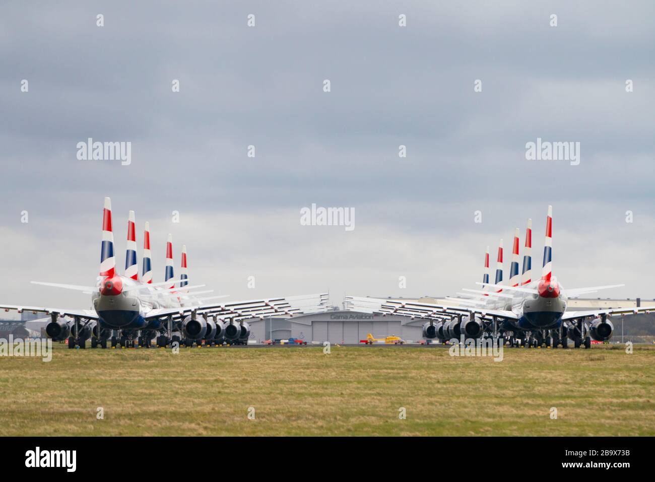 Glasgow, Scotland, UK. 25 March, 2020. Day two of the Government enforced lockdown in the UK. All shops and restaurants and most workplaces remain closed. Cities are very quiet with vast majority of population staying indoors. Pictured; British Airways passenger aircraft remain grounded and parked at Glasgow Airport. Iain Masterton/Alamy Live News Stock Photo