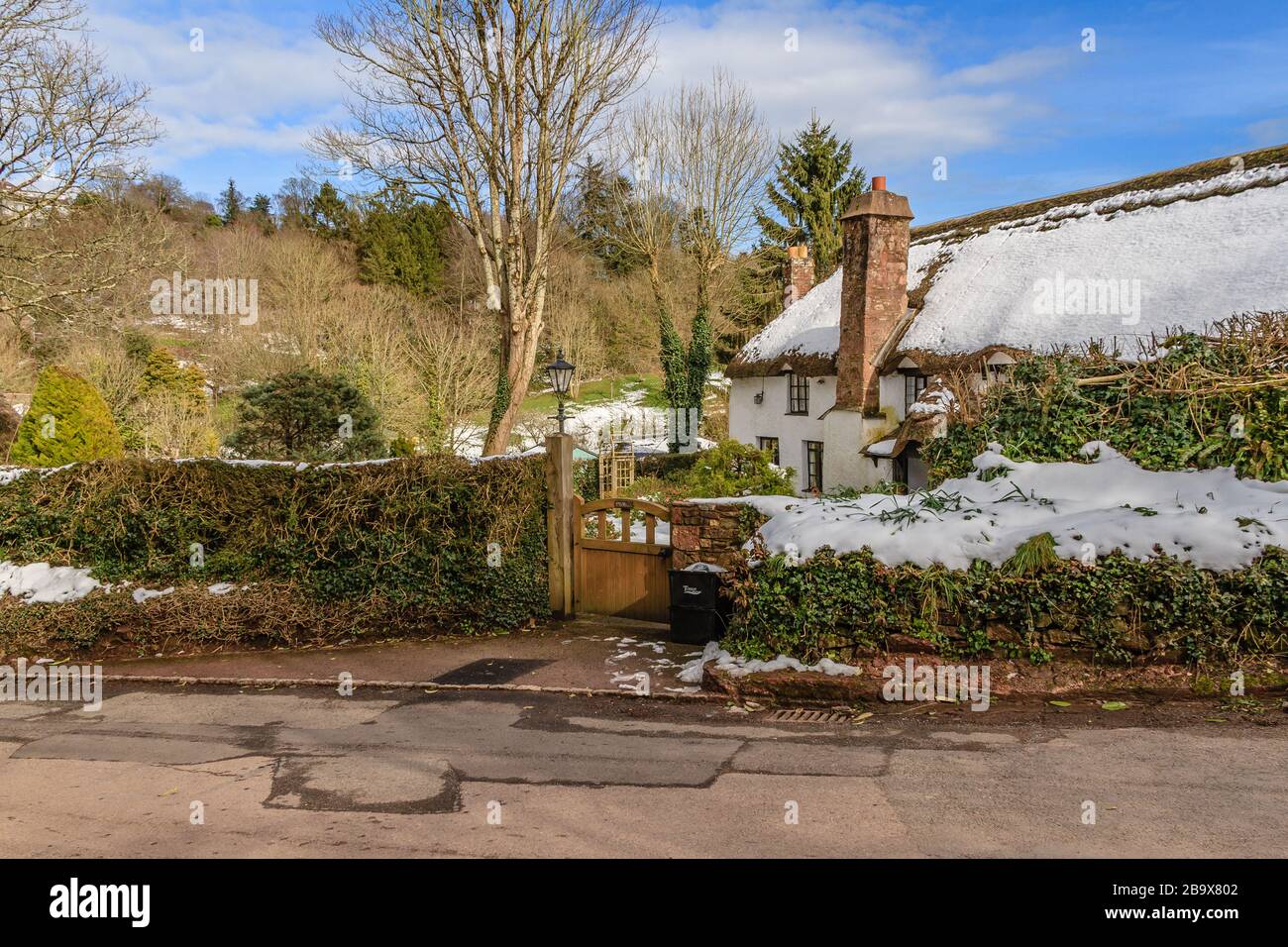 Snow on the roof of a thatched cottage in the historical village of Cockington, Torquay, Devon, UK. March 2018. Stock Photo
