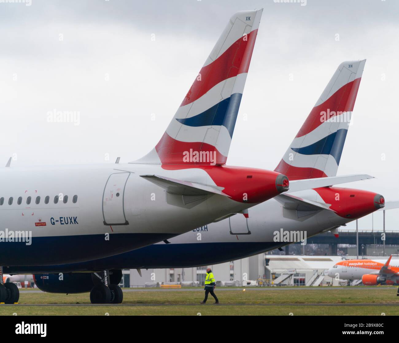 Glasgow, Scotland, UK. 25 March, 2020. Day two of the Government enforced lockdown in the UK. All shops and restaurants and most workplaces remain closed. Cities are very quiet with vast majority of population staying indoors. Pictured; British Airways passenger aircraft remain grounded and parked at Glasgow Airport. Iain Masterton/Alamy Live News Stock Photo