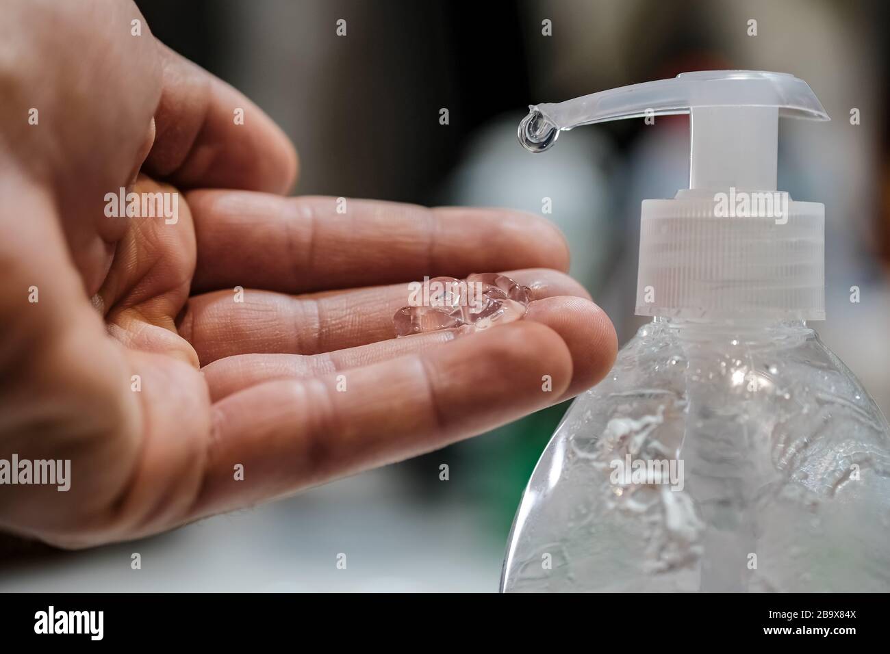 Man disinfecting with hand sanitizer dispenser,corona virus infection disease Stock Photo