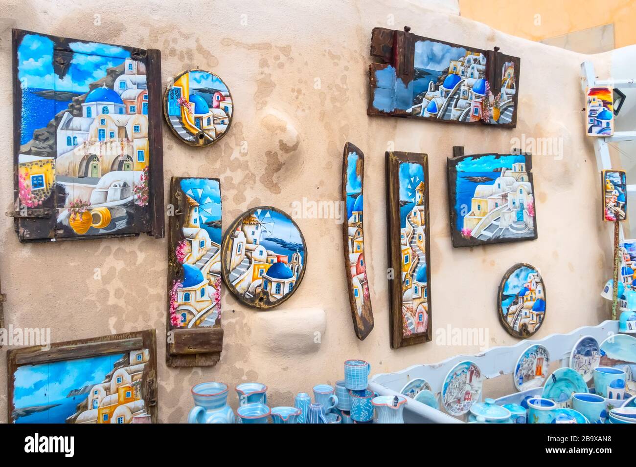 Santorini, Greece - April 26, 2019: Oia village street wall with traditional pictures in gift souvenir shop Stock Photo