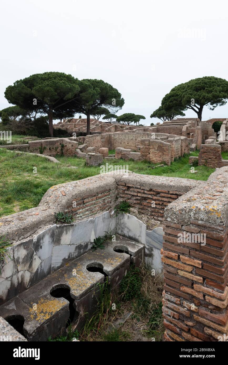 Rome. Italy. Ostia Antica. Remains of the Schola di Traiano (Schola Traianea / Guild-seat of Trajan).The latrine in the south corner of the building. Stock Photo