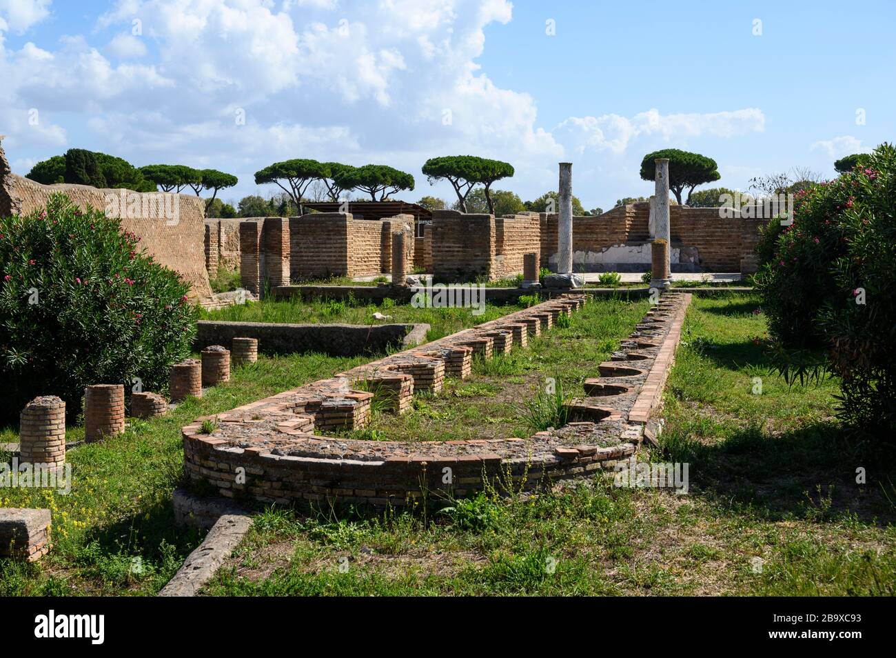 Rome. Italy. Ostia Antica. Remains of the Schola di Traiano (Schola Traianea / Guild-seat of Trajan).View of the peristylium and the long, narrow basi Stock Photo