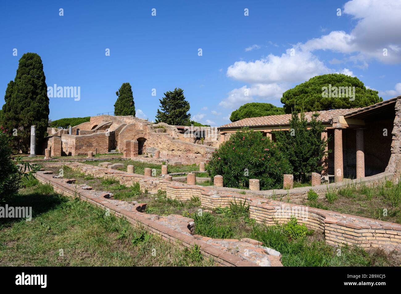 Rome. Italy. Ostia Antica. Remains of the Schola di Traiano (Schola Traianea / Guild-seat of Trajan).View of the peristylium and the long, narrow basi Stock Photo