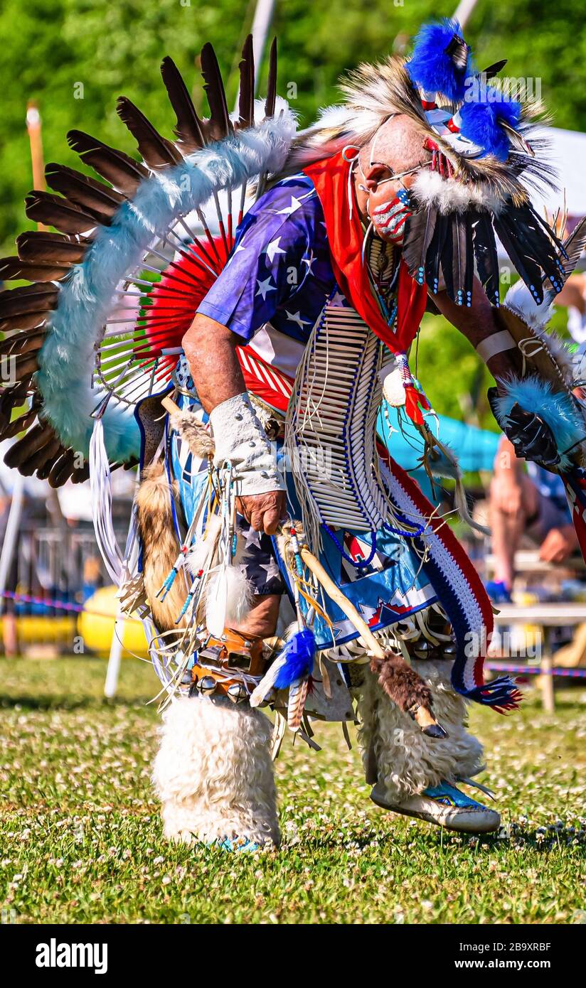 Vertical closeup shot of a person in a colorful traditional native ...