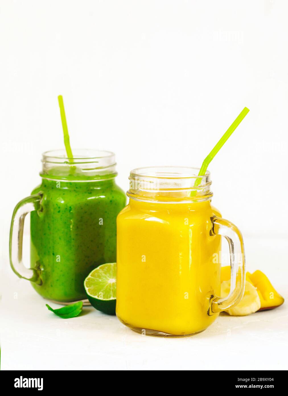 Banana Mango Smoothie and Green Spinach Avocado Smoothie in mason jars