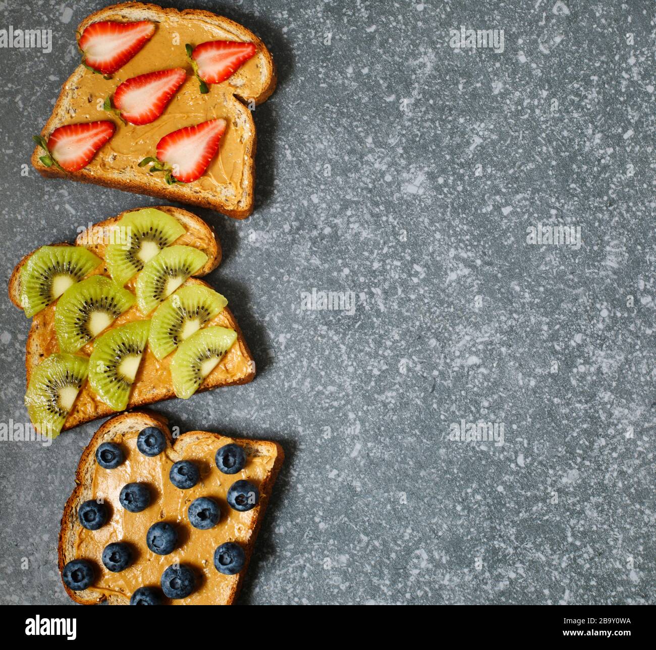 Nut butter and fruits vegan toasts Stock Photo Alamy