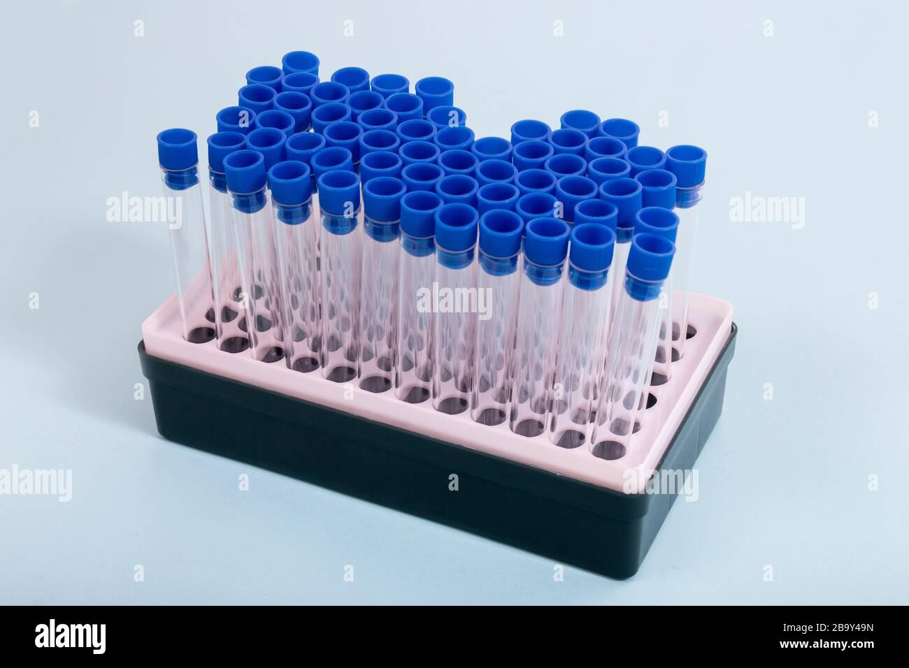 Vial rack filled with testing tubes isolated on blue background Stock ...