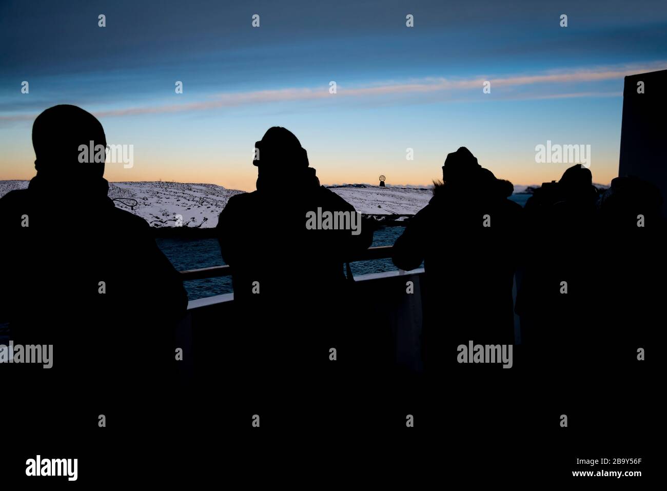 Passengers capture the moment MS Polarlys crosses the Arctic Circle sailing north, Vikingen, Rødøy Municipality, Norway. Stock Photo