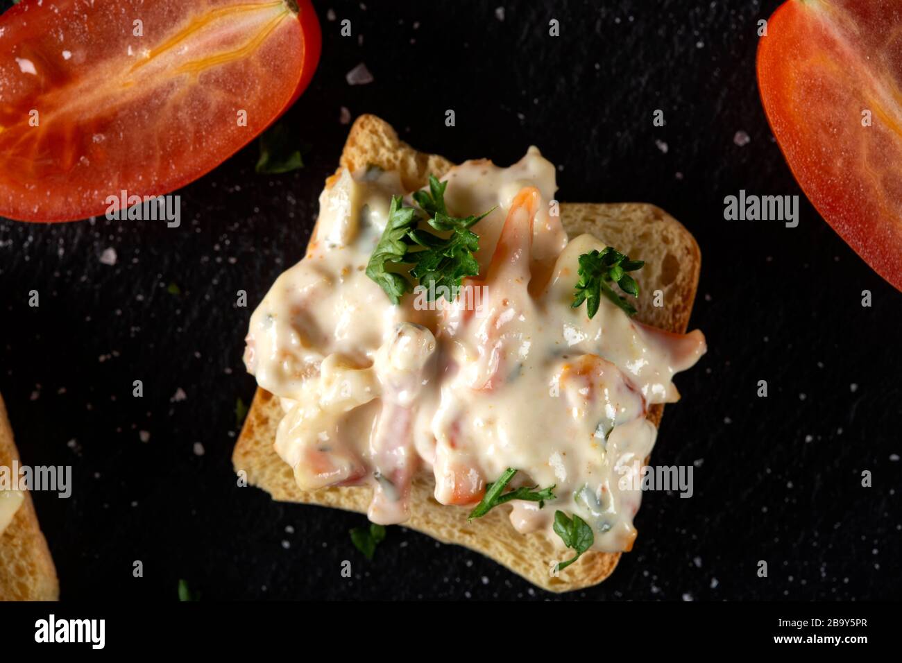 Chicken salad with hebs and mayonnaise on thin small bread slice - top view Stock Photo