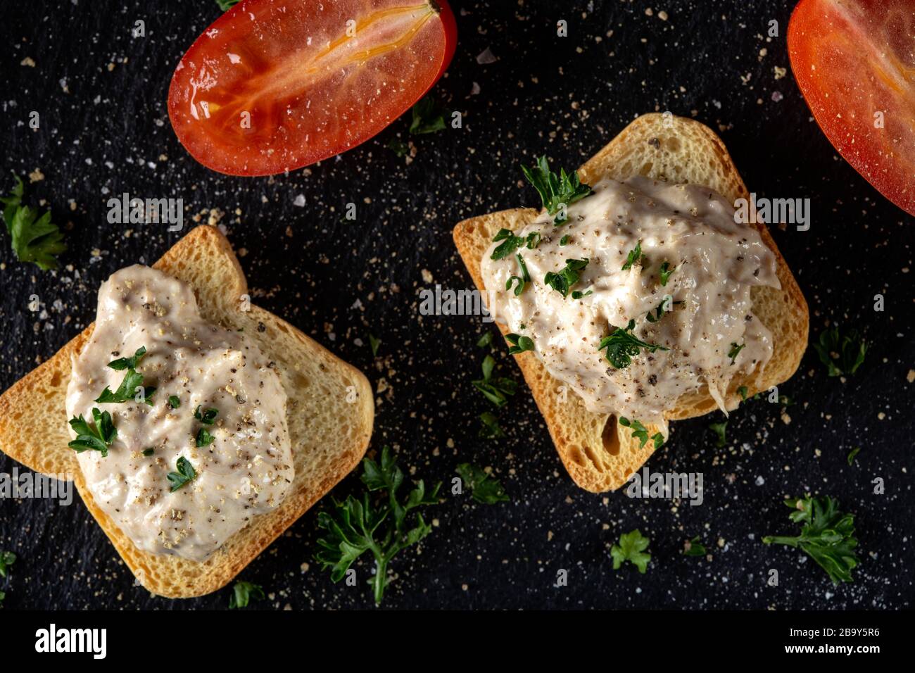 Tuna paste spread on small toast slices - top view Stock Photo