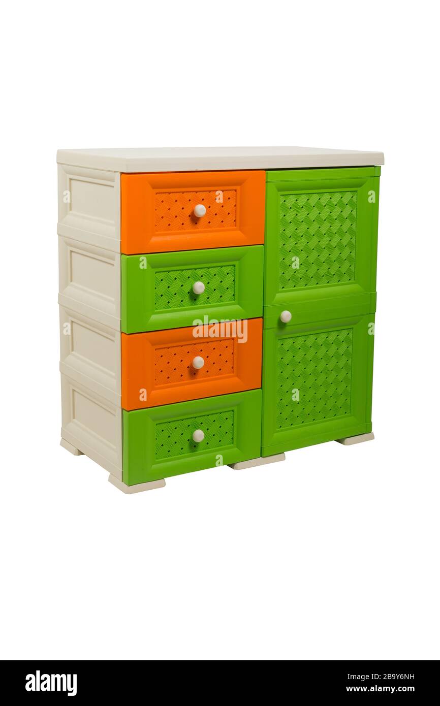 Chest of drawers on a white isolated background, plastic, three-color, beige-orange-green, studio light Stock Photo