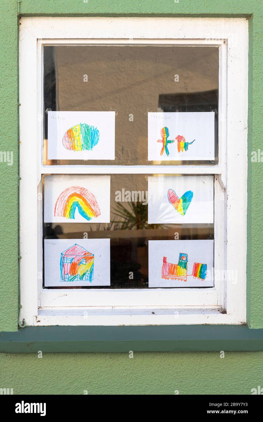 Appledore, North Devon, England. Wednesday 25th March 2020. Day two of the social distancing and self-isolation measures to limit the spread of Covid-19. With schools closed, children are decorating the windows of their homes with colourful Rainbow drawings in a bid to spread positivity in Appledore, North Devon. Credit: Terry Mathews/Alamy Live News Stock Photo