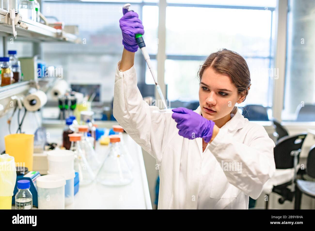 hand of girl drips from pipette onto glass slide Stock Photo Alamy