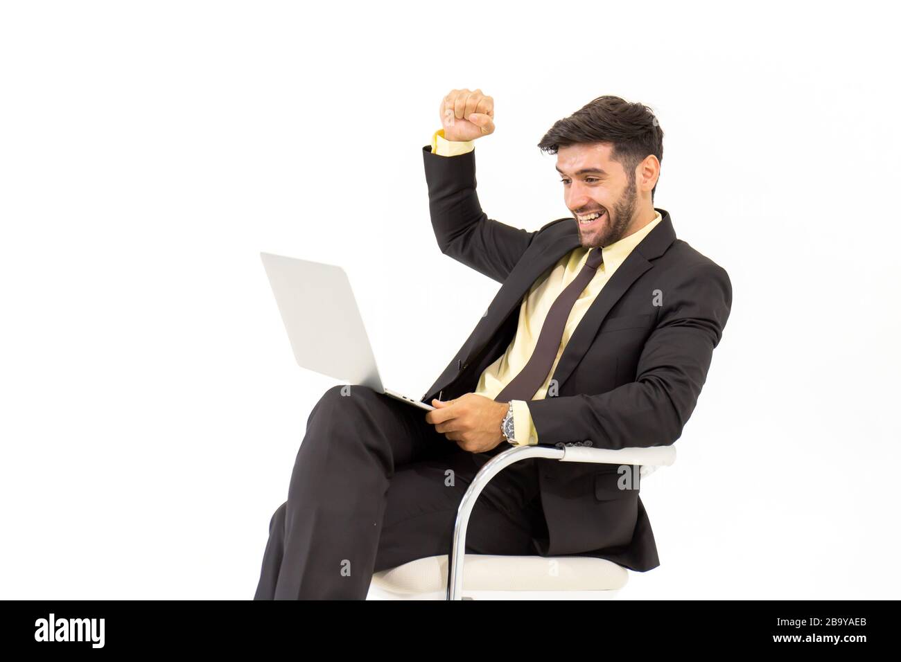 A handsome businessman sitting on a chair showing signs of happiness, isolated on white background, Stock Photo