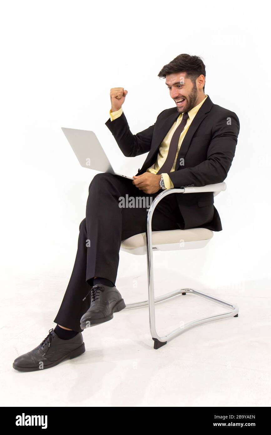 A handsome businessman sitting on a chair showing signs of happiness, isolated on white background, Stock Photo