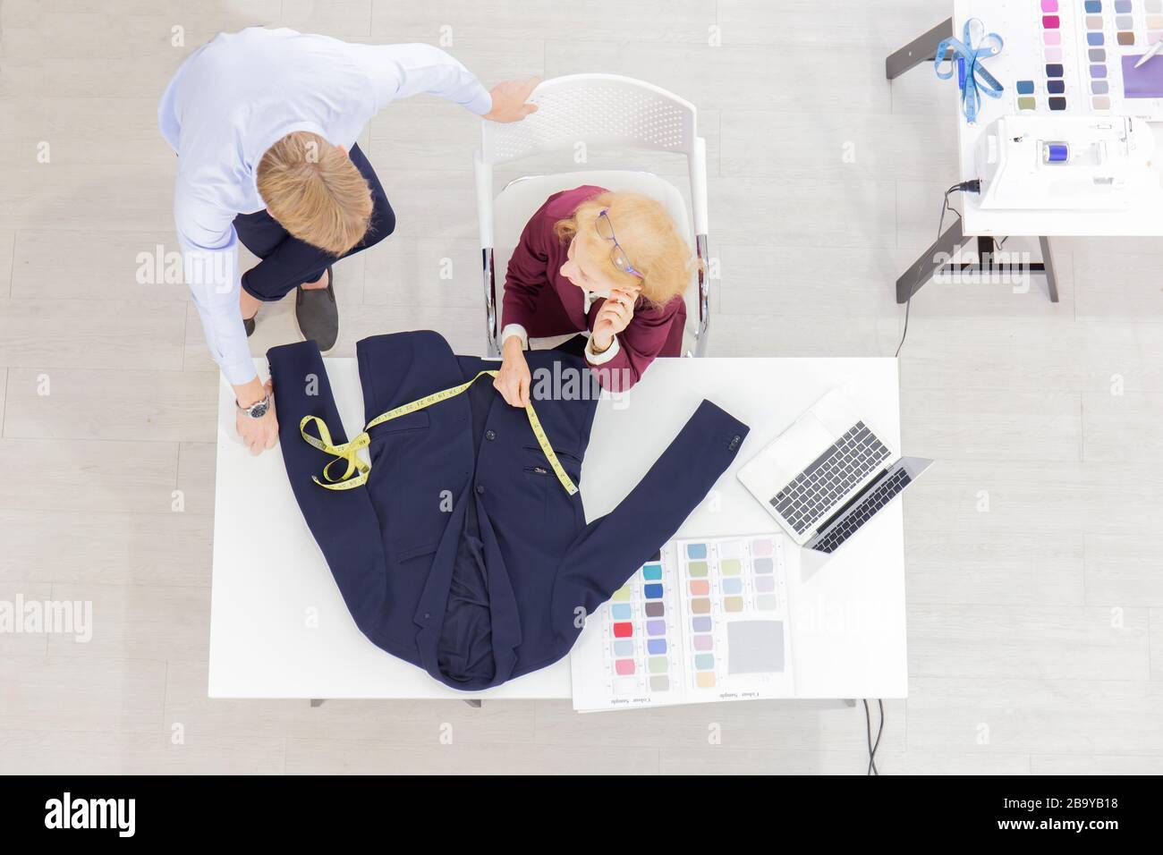Topview Professional team work designers, young men and elderly women in the office with a variety of fabric tones and equipment for various designs. Stock Photo