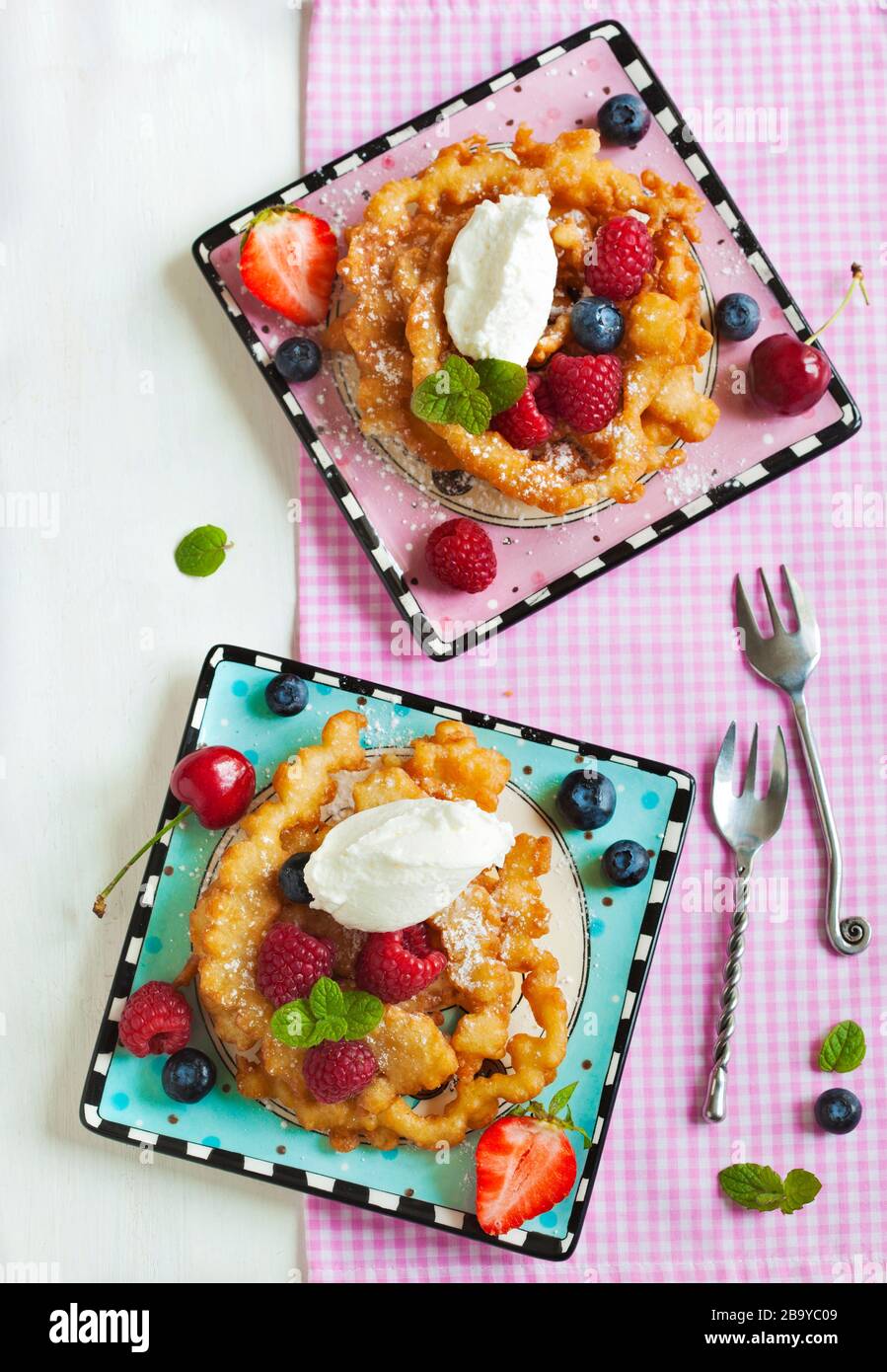 Funnel cakes with fresh berries and whipped cream Stock Photo Alamy