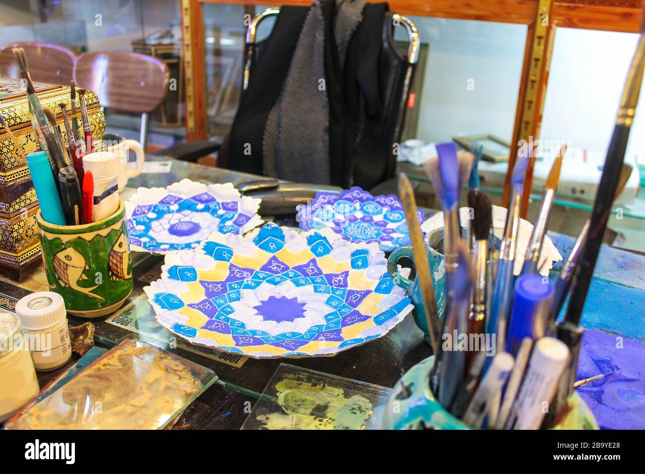 Persian Hand Painted Enamel Metal Plates Workstation in Iran Stock Photo
