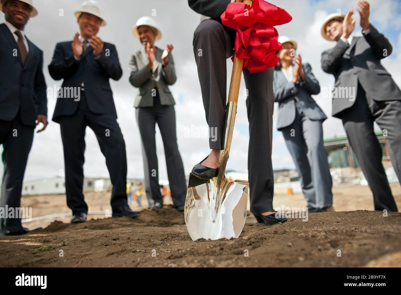 Group of business colleagues breaking ground on a project. Stock Photo
