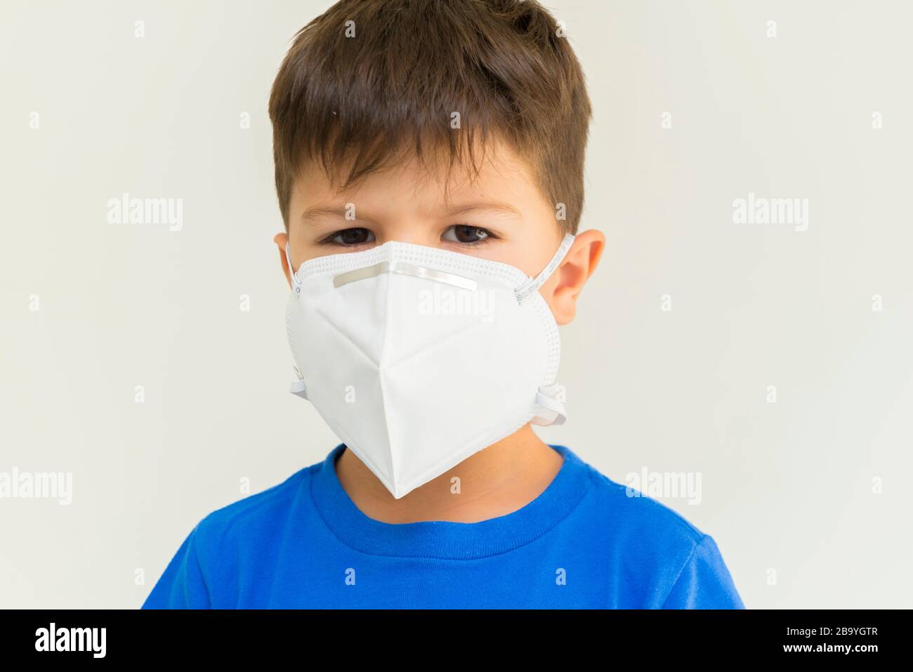Closeup of caucasian boy wearing surgical mask. Face mask for ...