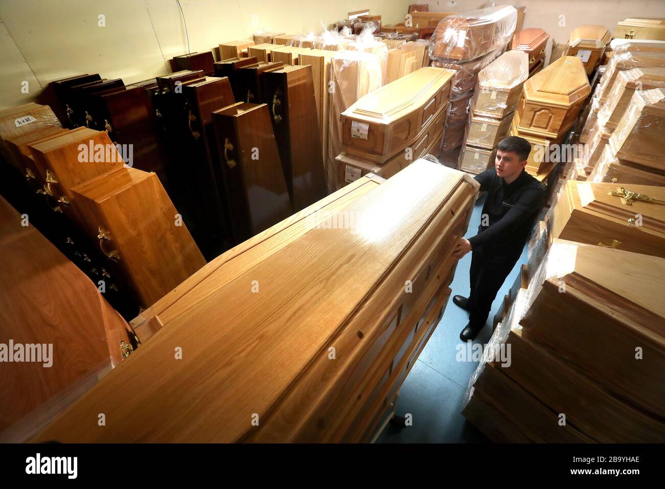 Declan Harley from Anderson Maguire Funeral Directors checks the empty coffins in the storage room at their offices in Glasgow. Funeral directors in Scotland's largest city are facing a backlog and on the verge of running out of mortuary space, the head of one family firm has said. Funerals are unable to take place until deaths have been registered and face-to-face appointments at registry offices are unavailable following coronavirus guidance. Stock Photo