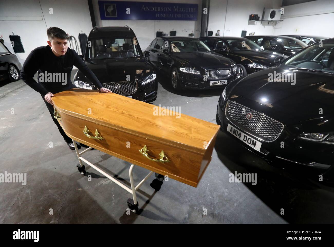 Declan Harley from Anderson Maguire Funeral Directors moves an empty coffin at their offices in Glasgow. Funeral directors in Scotland's largest city are facing a backlog and on the verge of running out of mortuary space, the head of one family firm has said. Funerals are unable to take place until deaths have been registered and face-to-face appointments at registry offices are unavailable following coronavirus guidance. Stock Photo