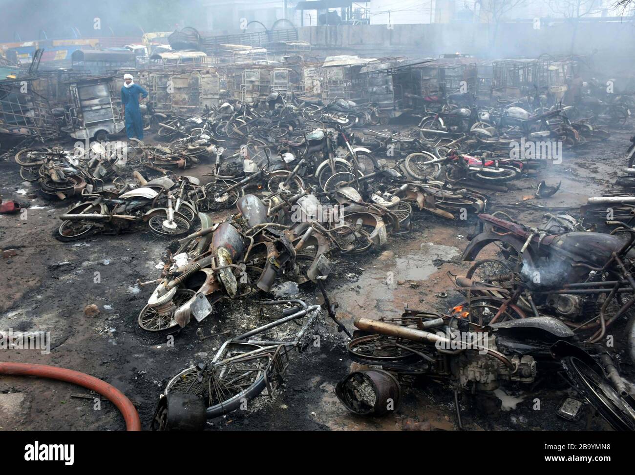 Lahore, Pakistan. 25th Mar, 2020. Burntout vehicles are seen at the