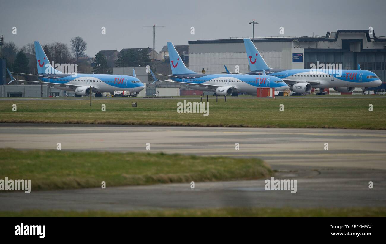 Glasgow, UK. 25th Mar, 2020. Pictured: TUI Airlines stands quiet on the tarmac at Glasgow International Airport. The jets Boeing 737-800MAX Aircraft and Boeing 757-200 Aircraft would normally be ferrying passengers to the Mediterranean and the Canary Islands, however due to the Coronavirus Pandemic all operations have ceased. Credit: Colin Fisher/Alamy Live News Stock Photo