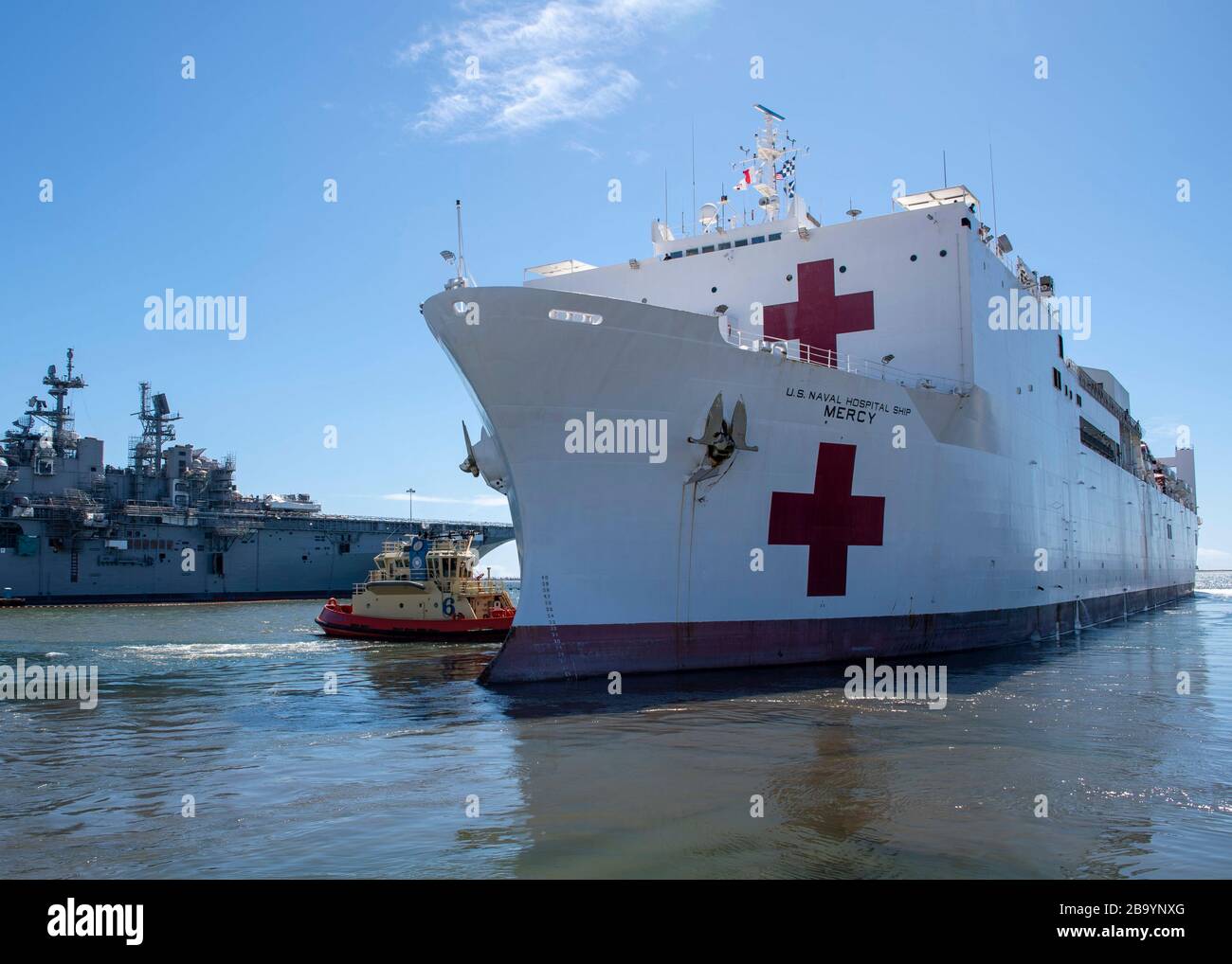 The U.S. Navy Military Sealift Command hospital ship USNS Mercy navigates the San Diego channel as it heads out for deployment to assist in the COVID-19, coronavirus response March 23, 2020 in San Diego, California. Stock Photo