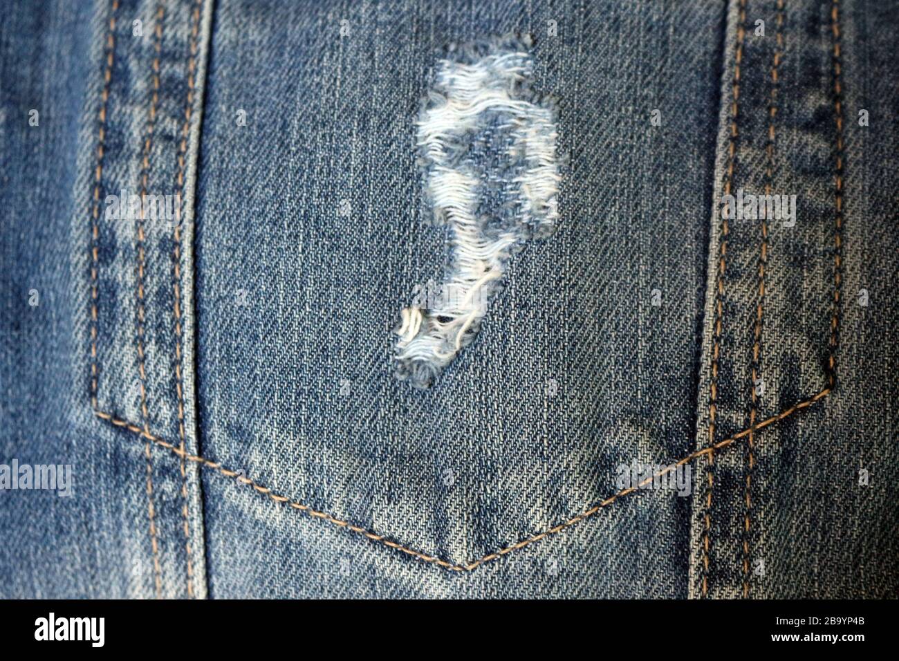 Destroyed (or destroyed / worn) jeans appeared in the 1980s, classic jeans with a younger, more modern personality. Stock Photo