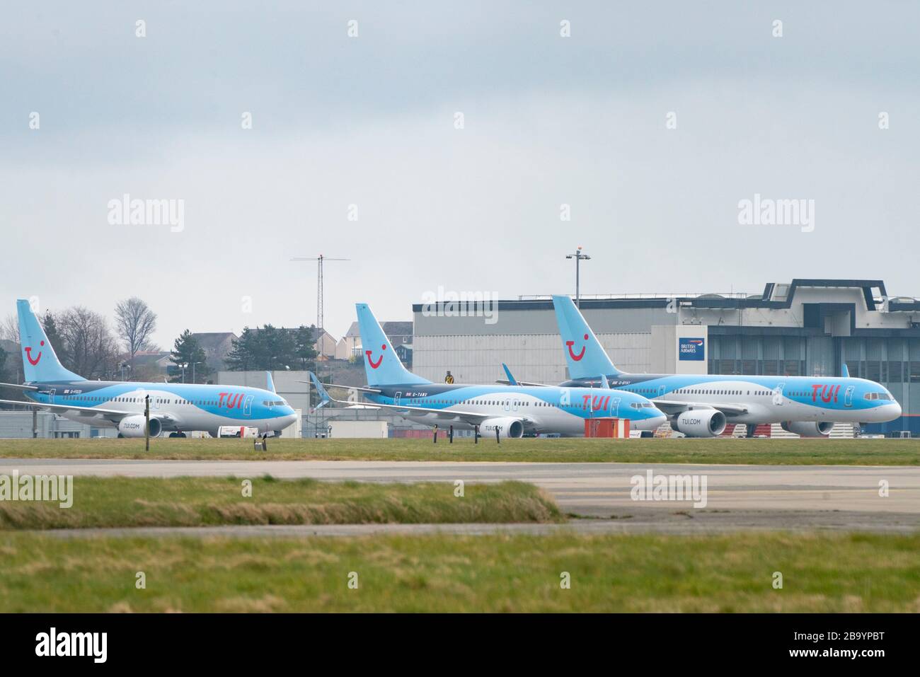 Glasgow, Scotland, UK. 25 March, 2020. Day two of the Government enforced lockdown in the UK. All shops and restaurants and most workplaces remain closed. Cities are very quiet with vast majority of population staying indoors. Pictured; Tui passenger aircraft remain grounded and parked at Glasgow Airport. Iain Masterton/Alamy Live News Stock Photo