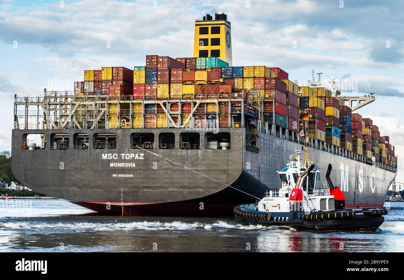 MSC Topaz Container Ship is manoeuvred by tugs when entering Hamburg Port Stock Photo