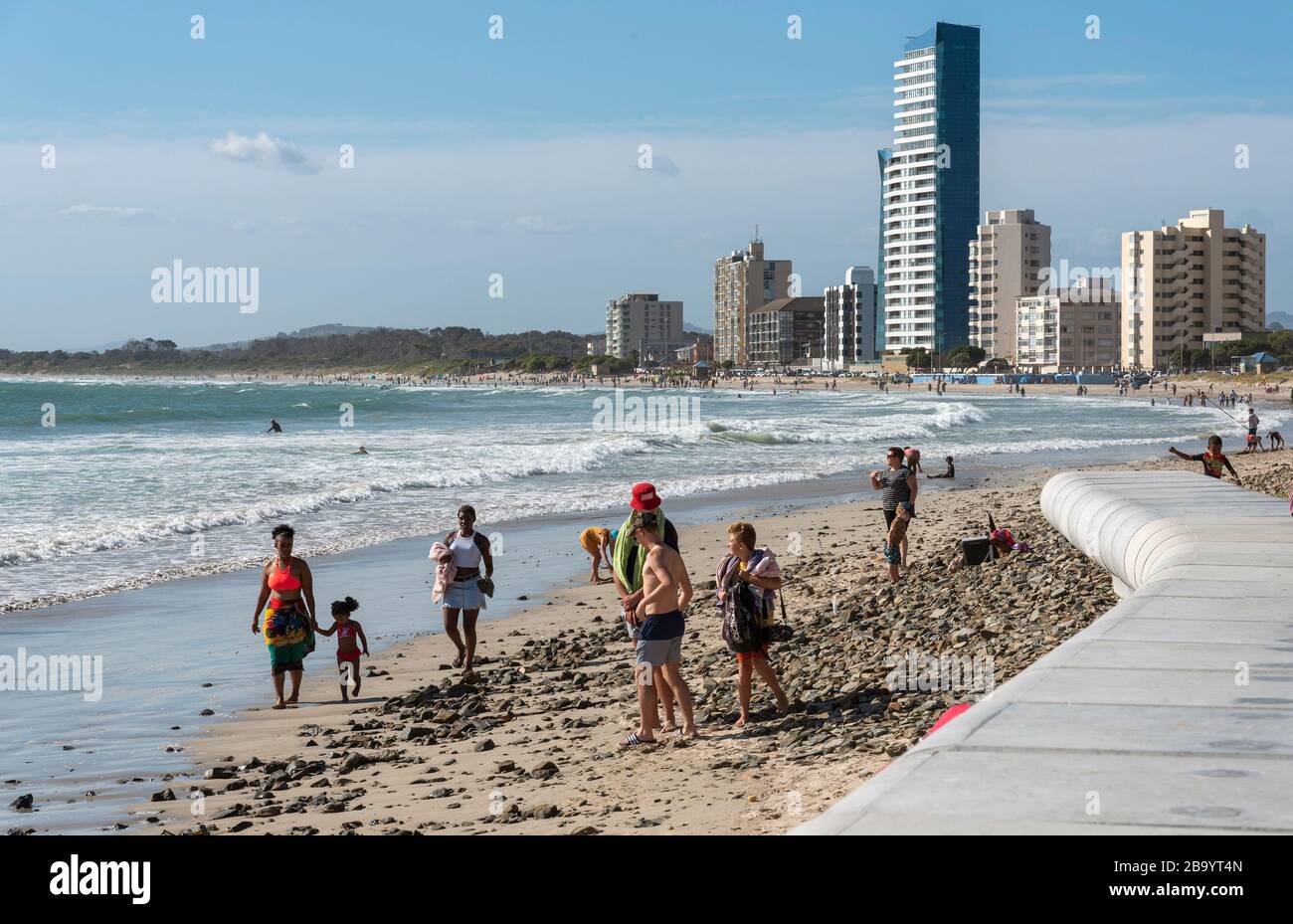 Strand, Somerset West, Western Cape, South Africa. Holidaymakers walk along the seafront  at Strand a popular seaside resort close to Somerset West. Stock Photo