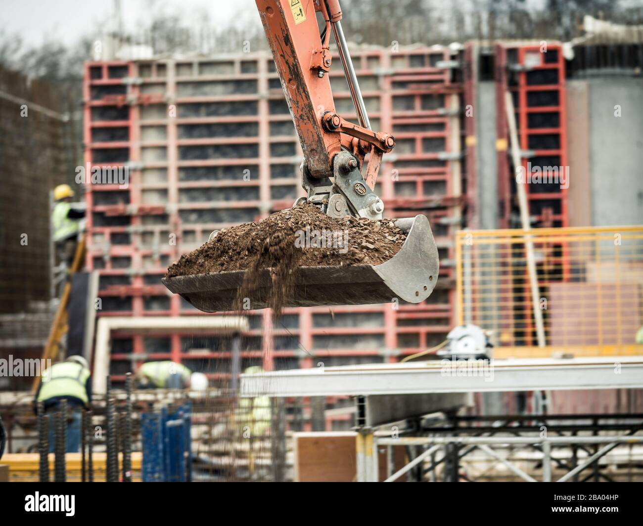 Excavator moving earth on building site Stock Photo