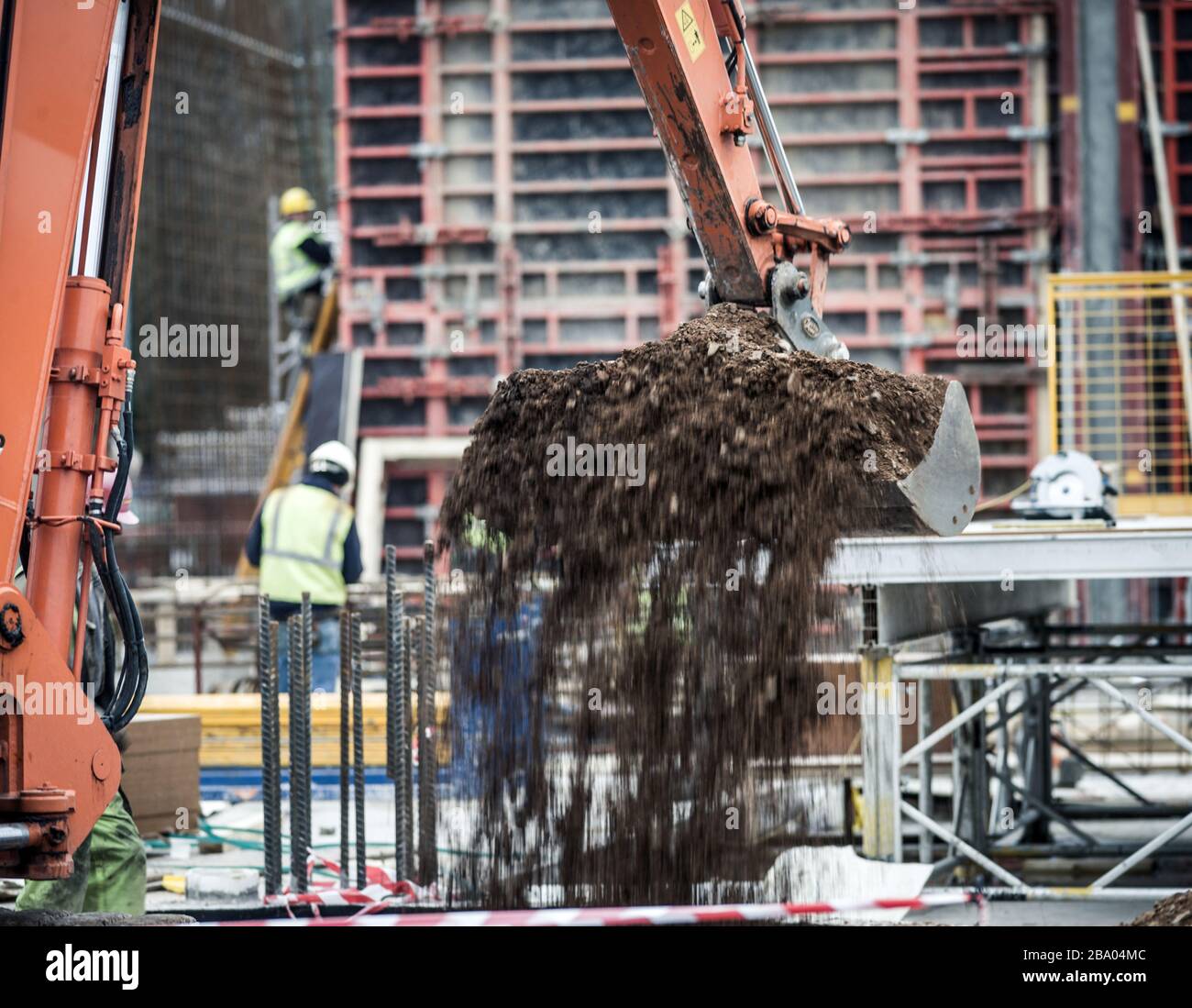 Excavator moving earth on building site Stock Photo