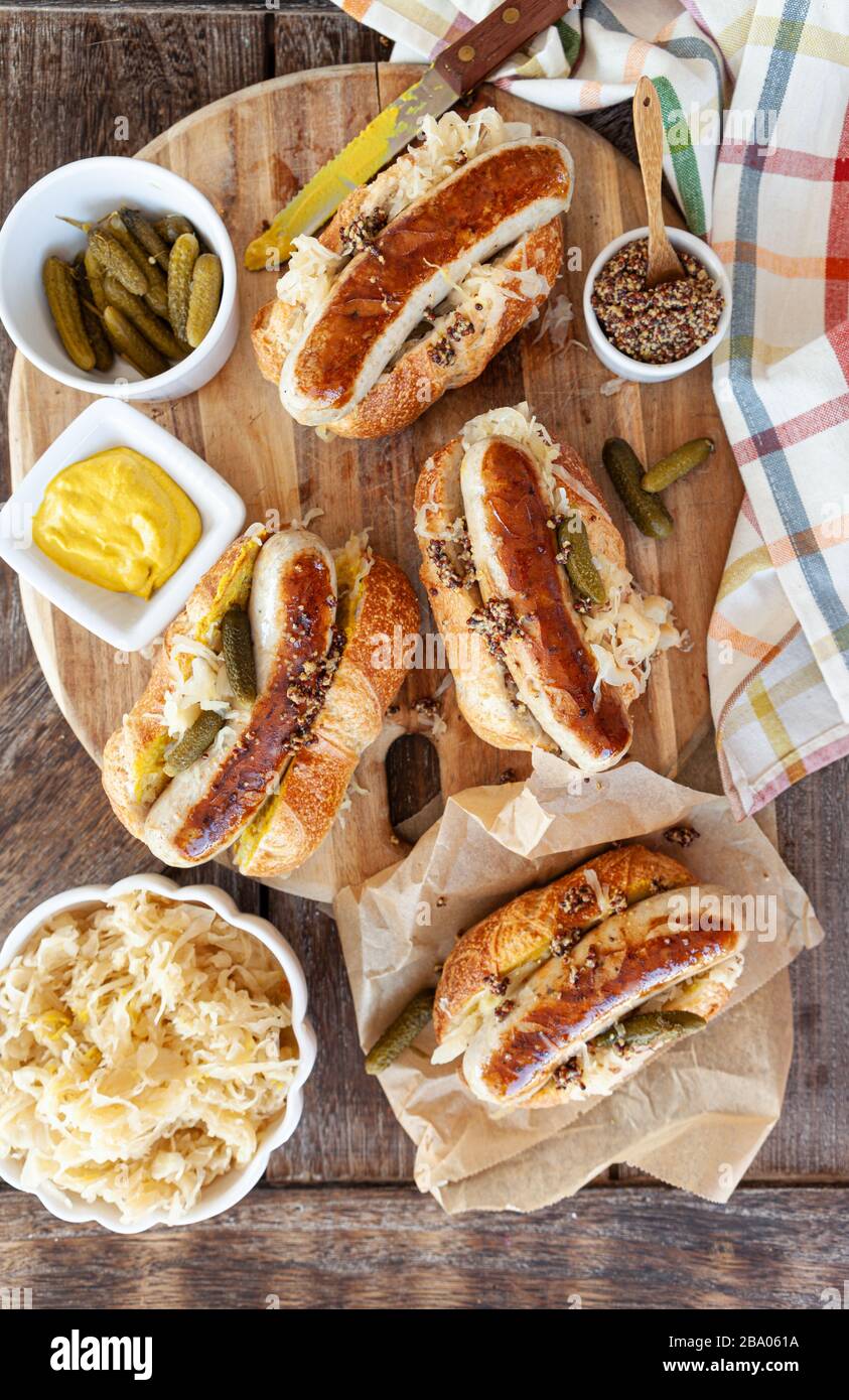 Delicious pork sausage hot dogs with sauerkraut and mustard Stock Photo