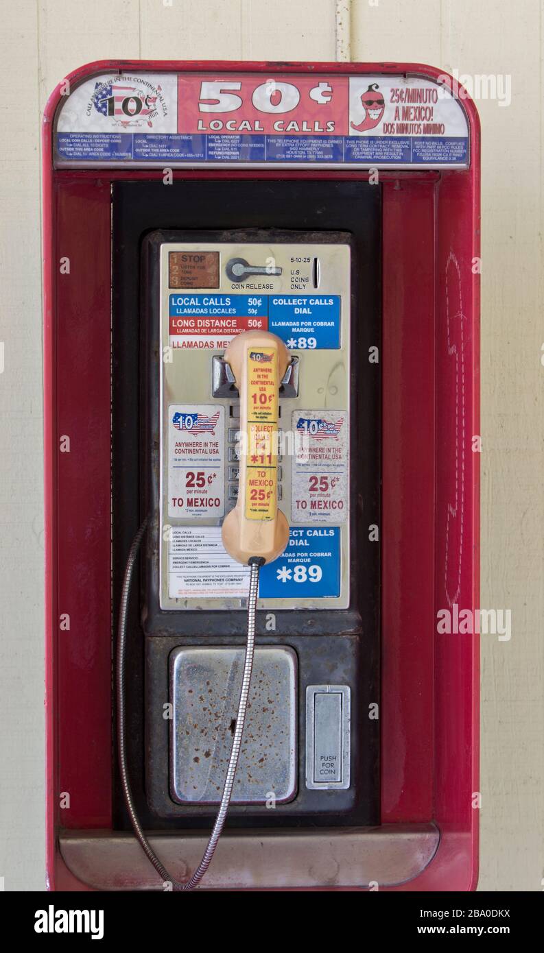 Classic Coin operated public pay telephone with receiver, coin release slot. Stock Photo