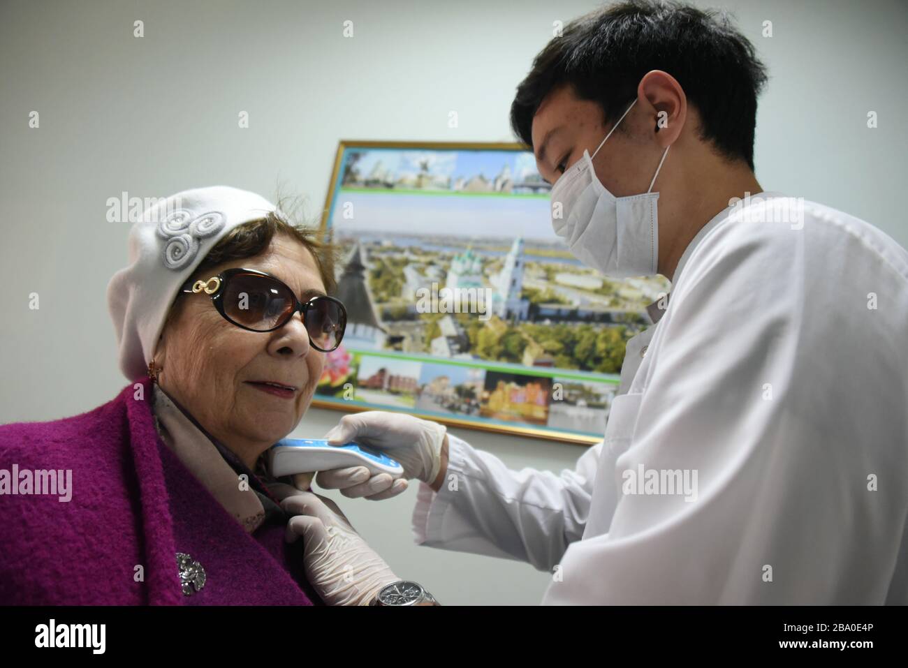 Medical volunteers in the polyclinic measure the temperature of the patients during the COVID-19 coronavirus pandemic in Astrakhan, Russia. Stock Photo