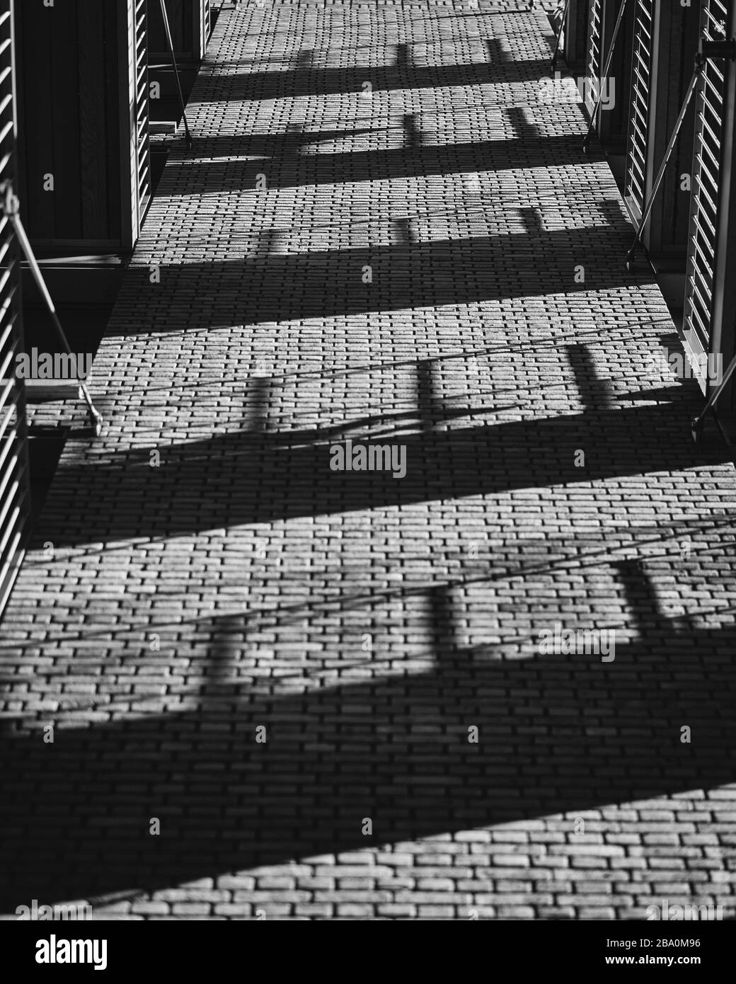 Balconies shadows cast on a brick wall Stock Photo