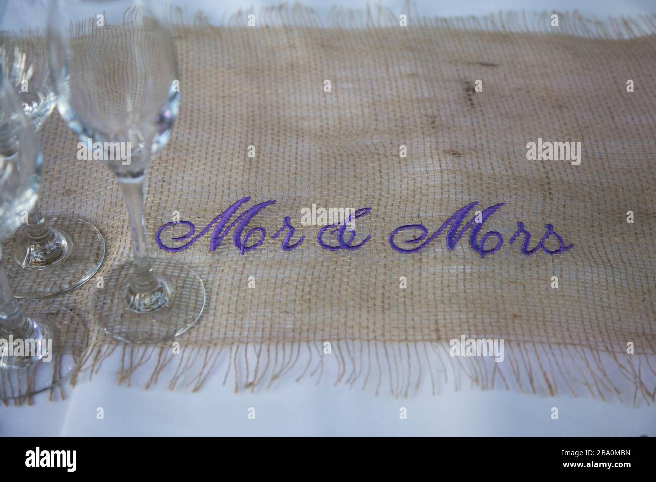 table runner with purple writing at a wedding day Stock Photo