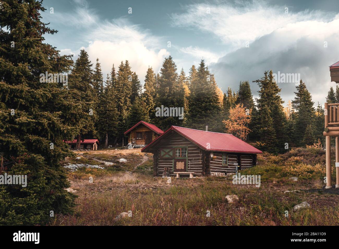 Wooden huts with sunshine in autumn forest on morning at Assiniboine ...