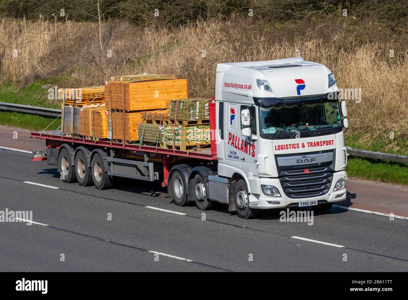 Pallants Haulage timber delivery trucks, lorry logistics, transportation, truck, timber products cargo carrier, DAF XF vehicle, European commercial transport, industry, M6 at Manchester, UK Stock Photo