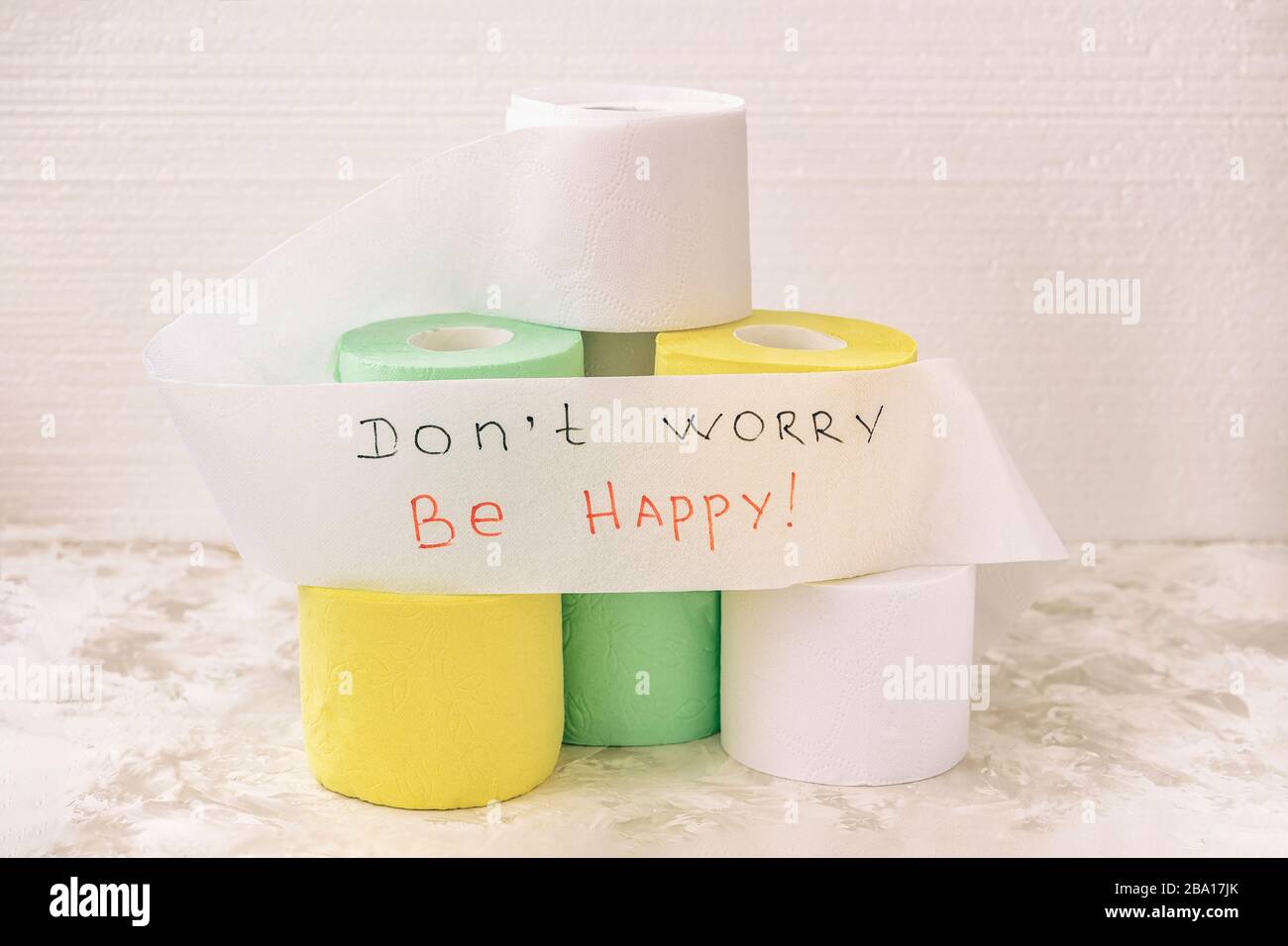 Pile of multicolored rolls of toilet paper on light background