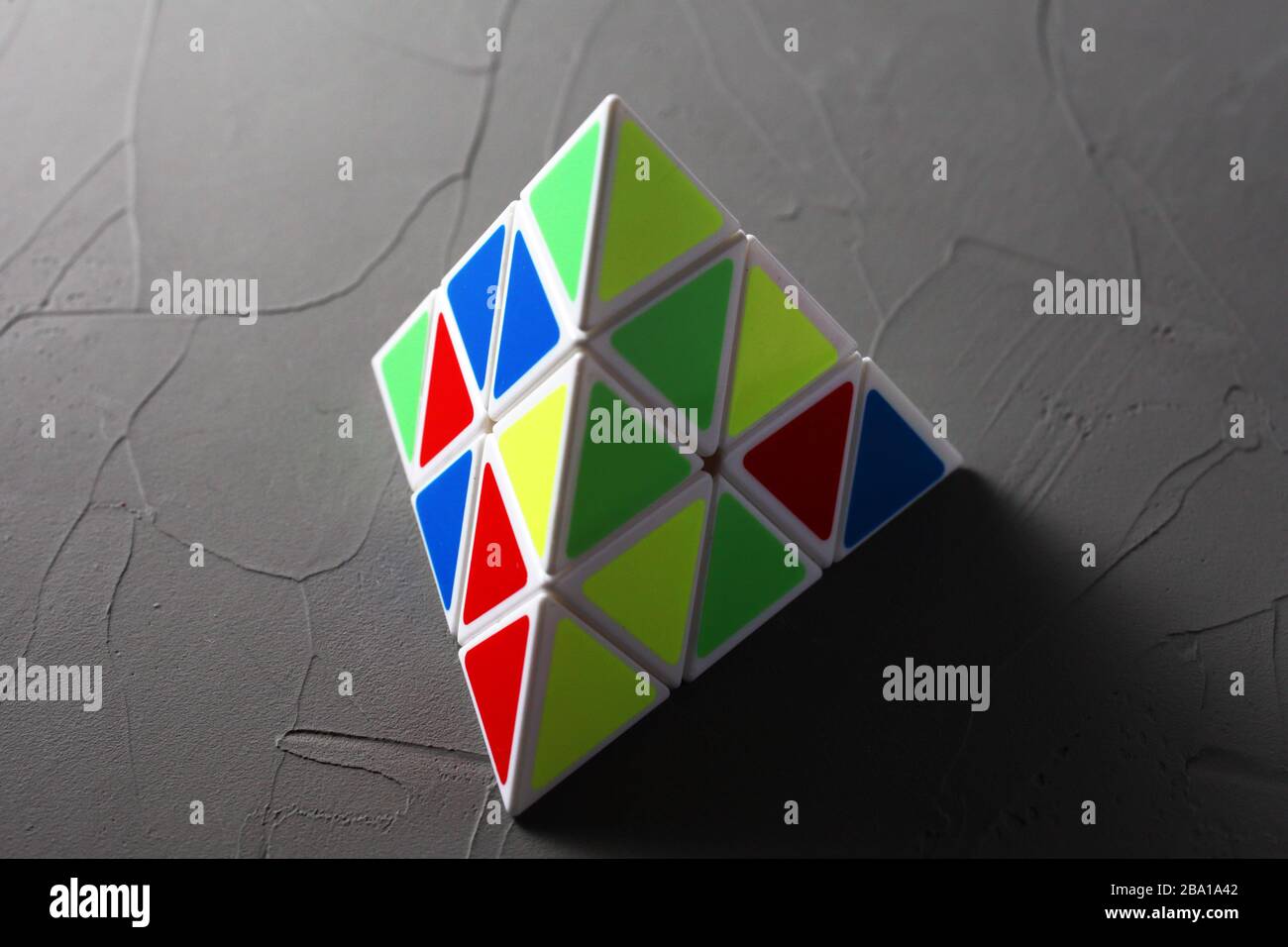puzzle pyramid on concrete background soft focus Stock Photo