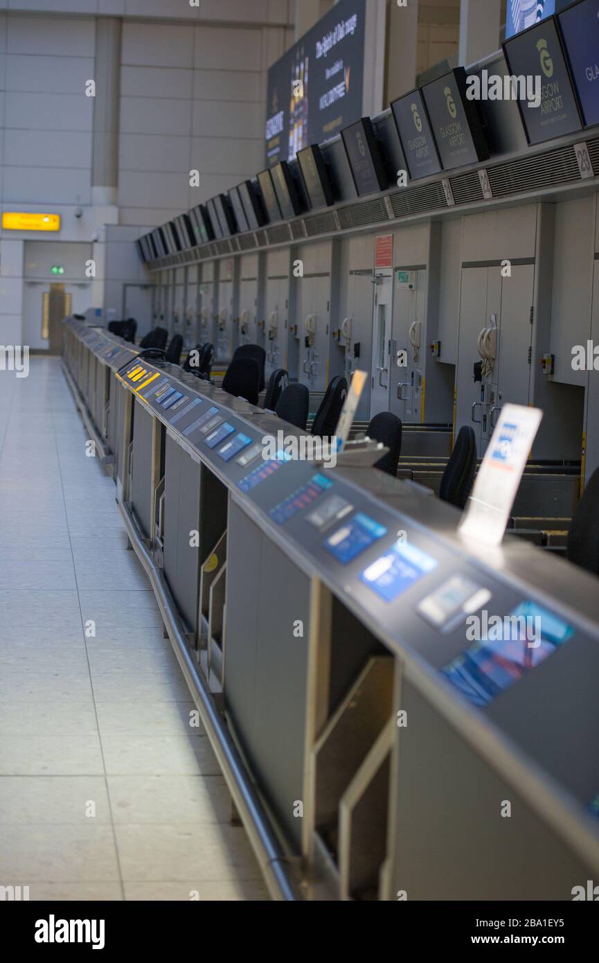 Glasgow, UK. 25th Mar, 2020. Pictured: Views the interior of Glasgow Airport passenger terminal showing the place deserted due to airlines suspending and cancelling flights due to the coronavirus pandemic. Credit: Colin Fisher/Alamy Live News Stock Photo